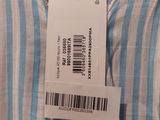 the label is on a dress that is hanging on a hanger