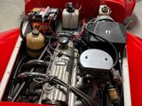 a red car with an engine in the back of it