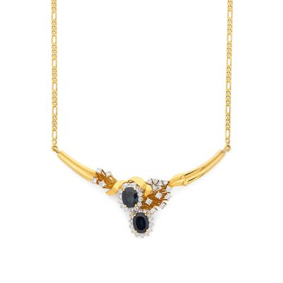 une photo d'un collier en or orné de pierres noires et blanches