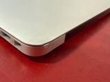 a close up of a laptop computer on a red surface