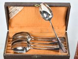 four spoons in a box with a spoon in it