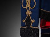 an image of a blue jacket with gold trims and a red ribbon