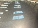 a reflection of a building on the windshield of a car