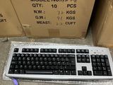 a keyboard and a box on the floor next to it