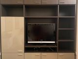 a picture of a living room with a flat screen tv