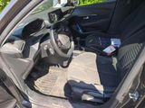 the interior of a car with the door open and the driver ' s seat down