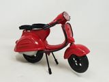 a red scooter that is sitting on a white surface