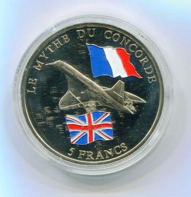 an image of a silver coin with a flag and a plane on it