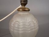 a glass lamp that is sitting on a table
