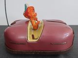 a red toy car with a bird on top of it