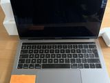 an apple macbook pro laptop computer sitting on top of a wooden table