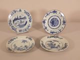 three blue and white plates with designs on them sitting on a table