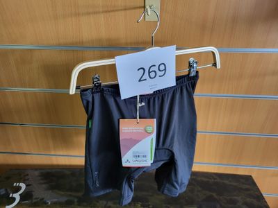 a sign on a hanger with a pair of pants on it