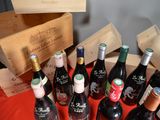 many bottles of wine sitting on a red table
