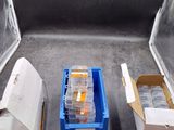 many boxes of medicine sitting on the floor next to each other