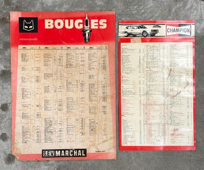 two pages of old car sales brochures on a concrete surface