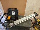 a picture of a stapler sitting on top of a table next to a tool box