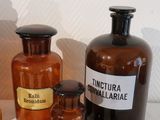 many bottles of medicine sitting on a shelf next to each other