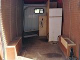 a red van that has a small kitchen in the back of it