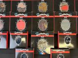 a lot of different colored eyeshades on a black table