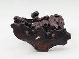 a small sculpture of a rock on a white surface