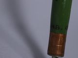 a close up view of a green and copper pipe