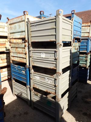 a man standing in front of a stack of crates