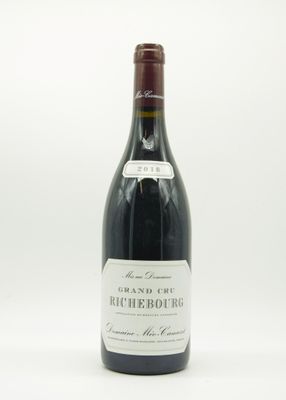 la bouteille de vin est posée sur une surface blanche