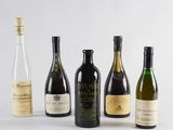 six bouteilles de vin sont alignées sur une surface blanche