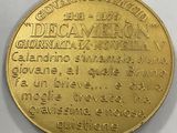 a close up of a gold coin on a white surface