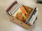 a cardboard box full of cds and cds on the floor