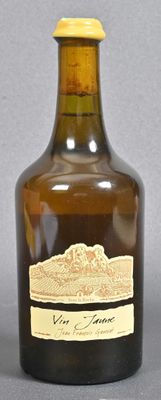 bottles of wine are lined up on a table with a gray background