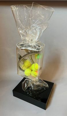 tennis balls in a clear plastic bag with a black base