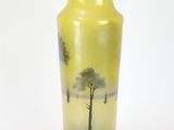 a yellow vase with a painting of a tree on it