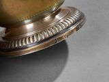 a gold vase sitting on top of a table