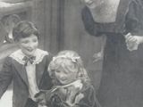 a black and white photo of a woman and two children with a dog
