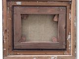 an old picture frame with a piece of wood in the middle of it