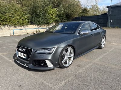 the audi rs7 is parked in a parking lot