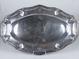 an antique silver plate with a decorative design on the edge