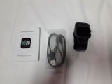 a smart watch sitting next to a charger on a table