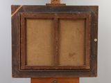 an old wooden easel with a painting on top of it