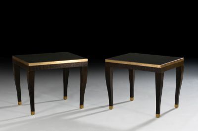 two black and gold side tables on a white surface