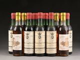 a group of six bottles of wine sitting on top of a table