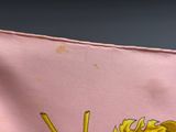 someone is holding a pink bag with a picture of a dragon on it