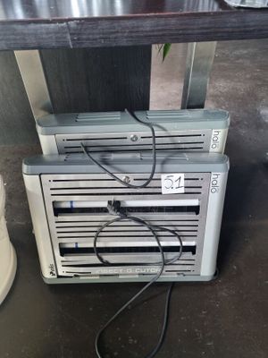 a small air conditioner sitting on the floor next to a potted plant