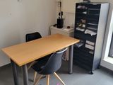 a desk and chair in a room with a window