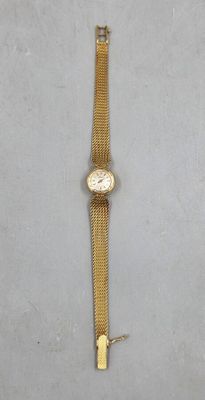 an image of a gold wrist watch with a chain around it