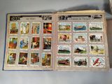 an open book with pictures of people and animals on it
