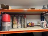 a shelf that has many different types of gas cans on it