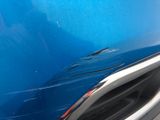 a close up of a car door handle with a blue background